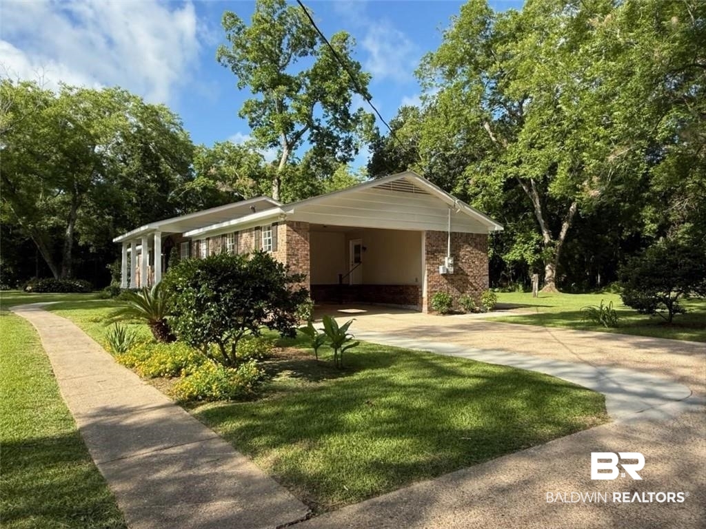 10374 Henderson Camp Road Grand Bay, AL 36541 - Photo 18 of 21 View of front of property with brick siding, a front lawn, driveway, and a carport