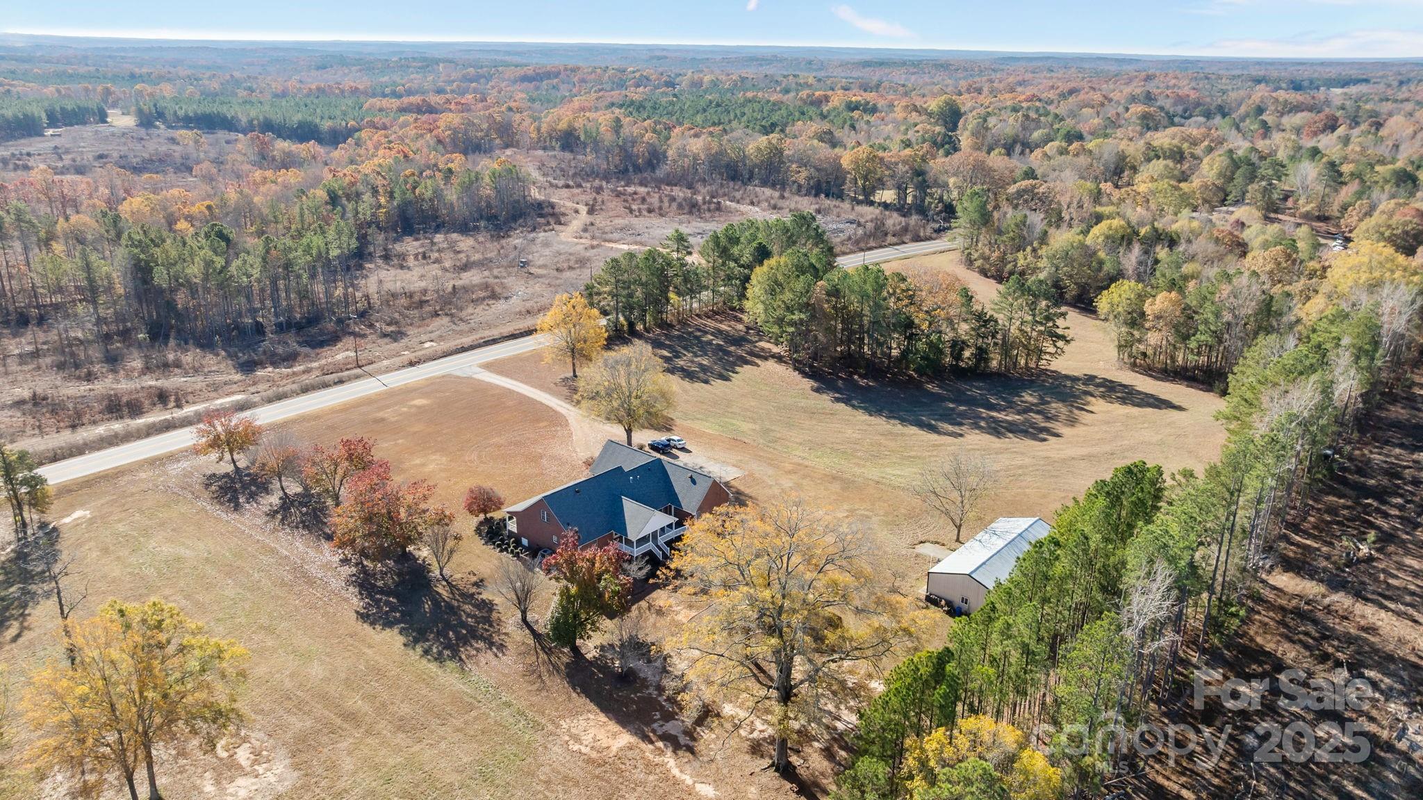 2363 Armenia Road Chester, SC 29706 - Photo 32 of 36 an aerial view of a house with a yard and lake view