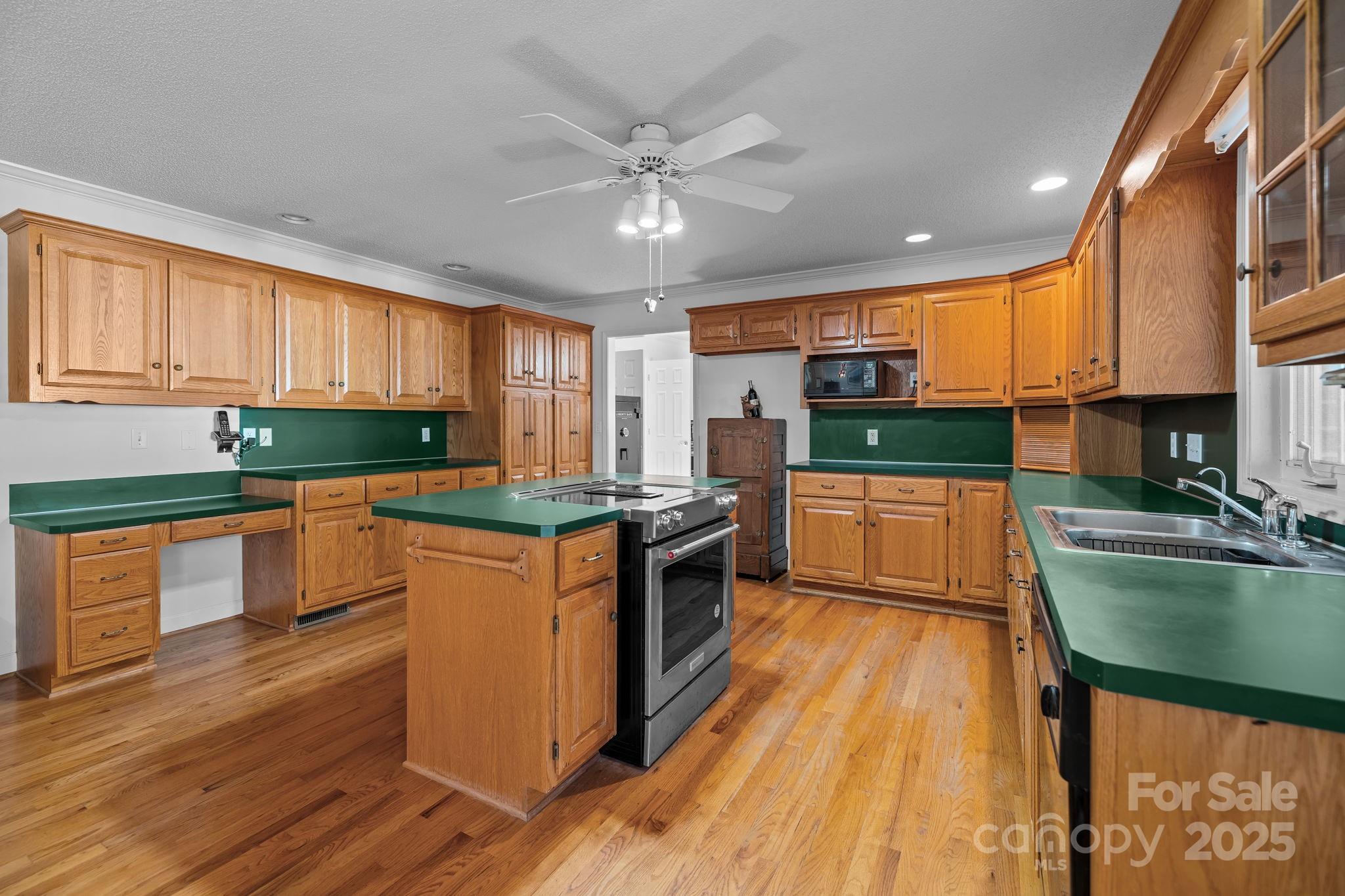 2363 Armenia Road Chester, SC 29706 - Photo 9 of 36 a kitchen with stainless steel appliances granite countertop wooden cabinets a sink dishwasher a stove and a refrigerator with wooden floor