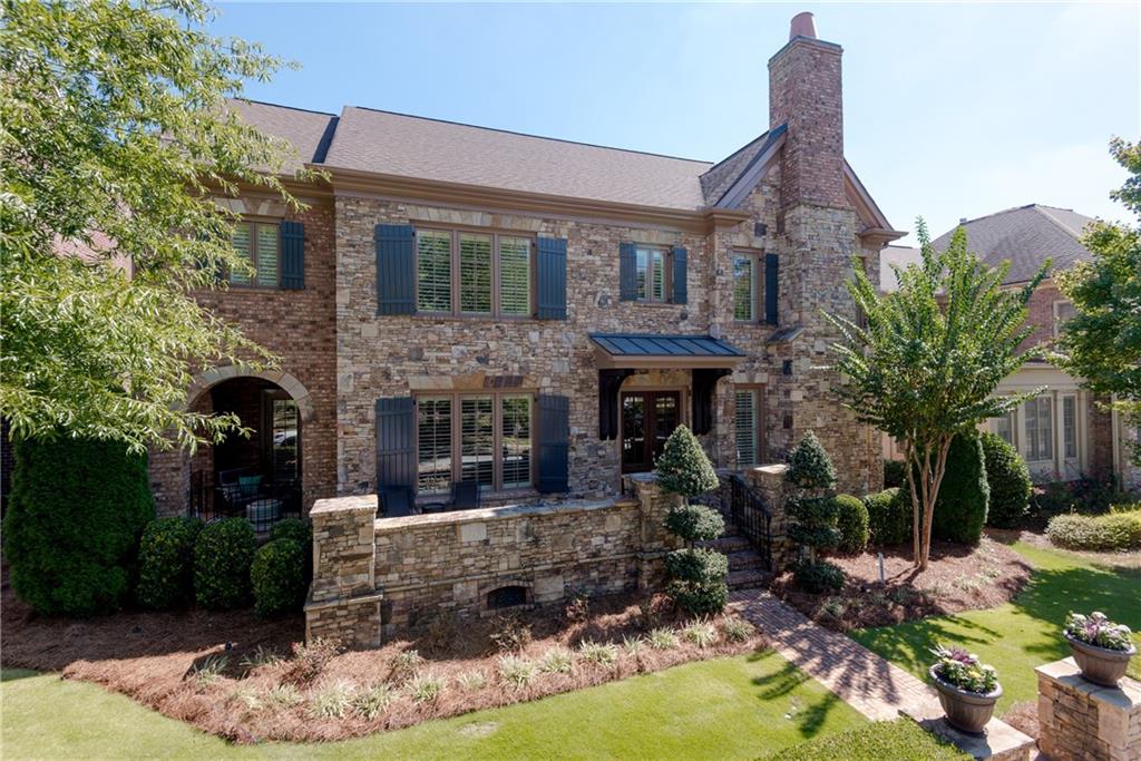 8055 Georgetown Circle Suwanee, GA 30024 - Photo 1 of 1 STUNNING BRICK CARRIAGE STYLE HOME WITH SIX BEDROOMS