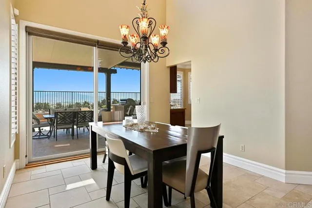 a view of a dining room with furniture and chandelier