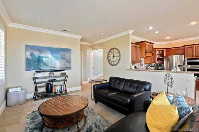 a living room with furniture and kitchen view