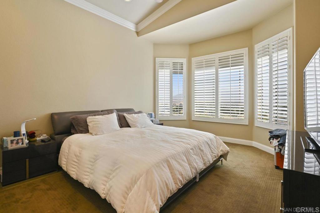 1035 Park Meadows Road Chula Vista, CA 91915 - Photo 17 of 35 a large bed sitting in a bedroom next to a window