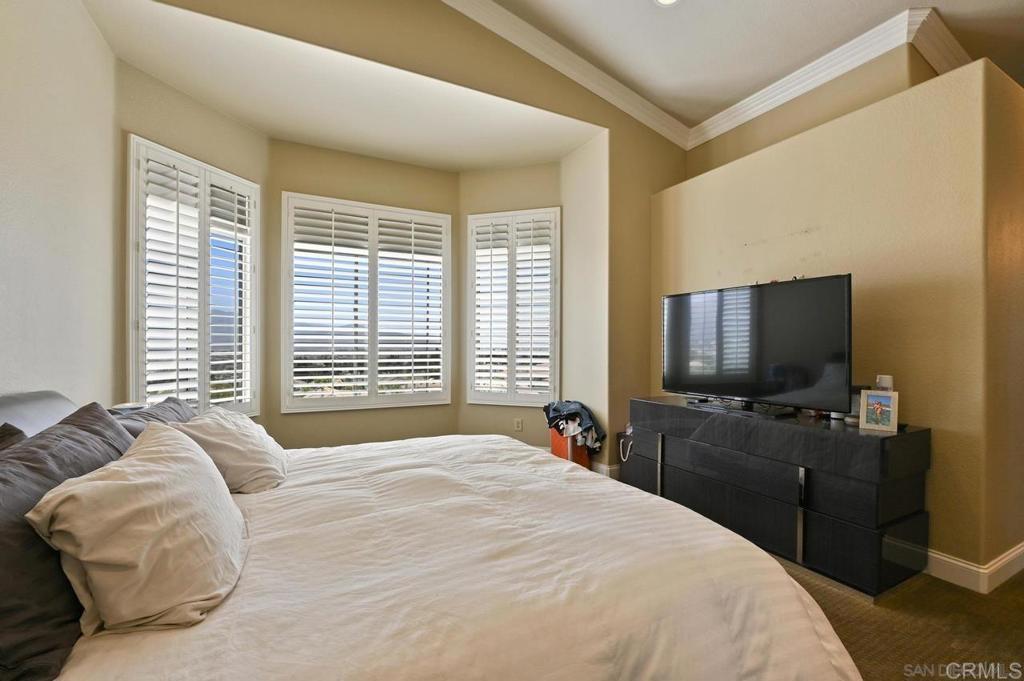 1035 Park Meadows Road Chula Vista, CA 91915 - Photo 18 of 35 a bedroom with a bed and a flat tv screen on wall