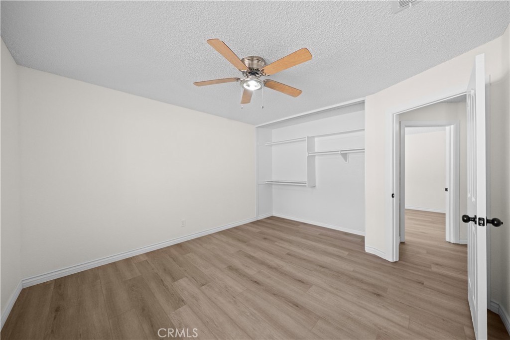 5498 Shadow Lane Rancho Cucamonga, CA 91737 - Photo 15 of 51 an empty room with wooden floor ceiling fan and window