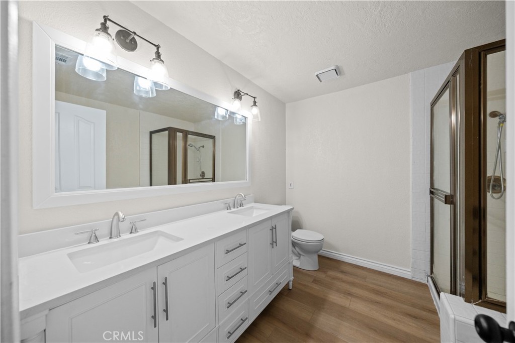 5498 Shadow Lane Rancho Cucamonga, CA 91737 - Photo 18 of 51 a bathroom with a double vanity sink mirror and toilet