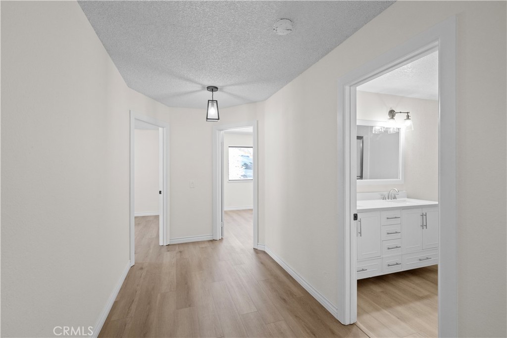5498 Shadow Lane Rancho Cucamonga, CA 91737 - Photo 19 of 51 a view of a hallway with wooden floor