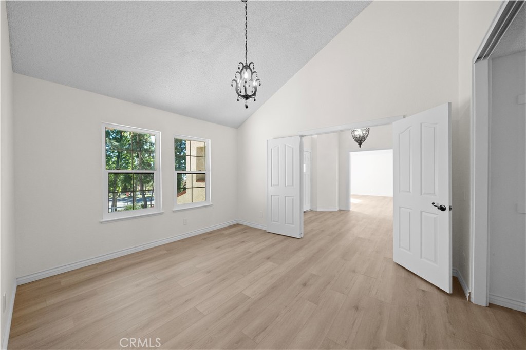 5498 Shadow Lane Rancho Cucamonga, CA 91737 - Photo 21 of 51 a view of an empty room with wooden floor and a window