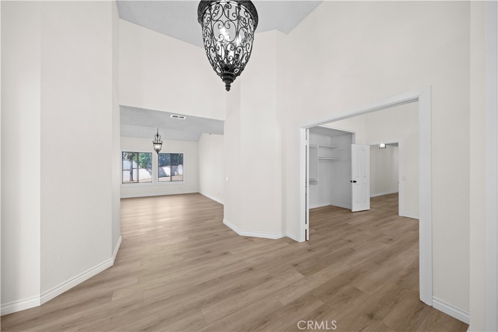 5498 Shadow Lane Rancho Cucamonga, CA 91737 - Photo 23 of 51 a view of a room with wooden floor and a kitchen