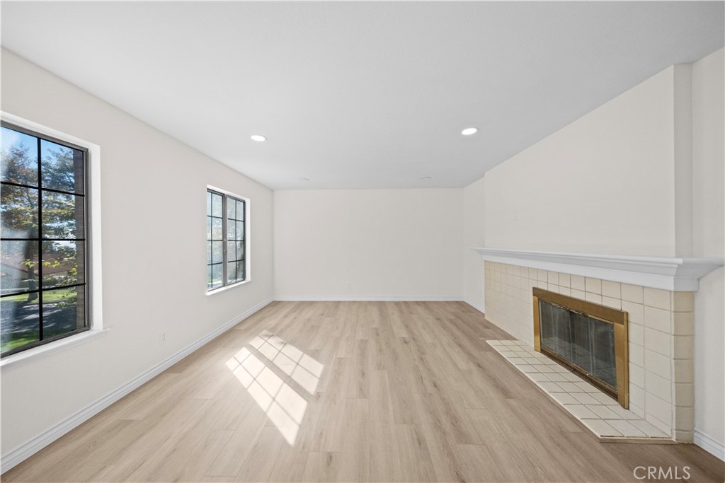 5498 Shadow Lane Rancho Cucamonga, CA 91737 - Photo 24 of 51 an empty room with windows and fireplace
