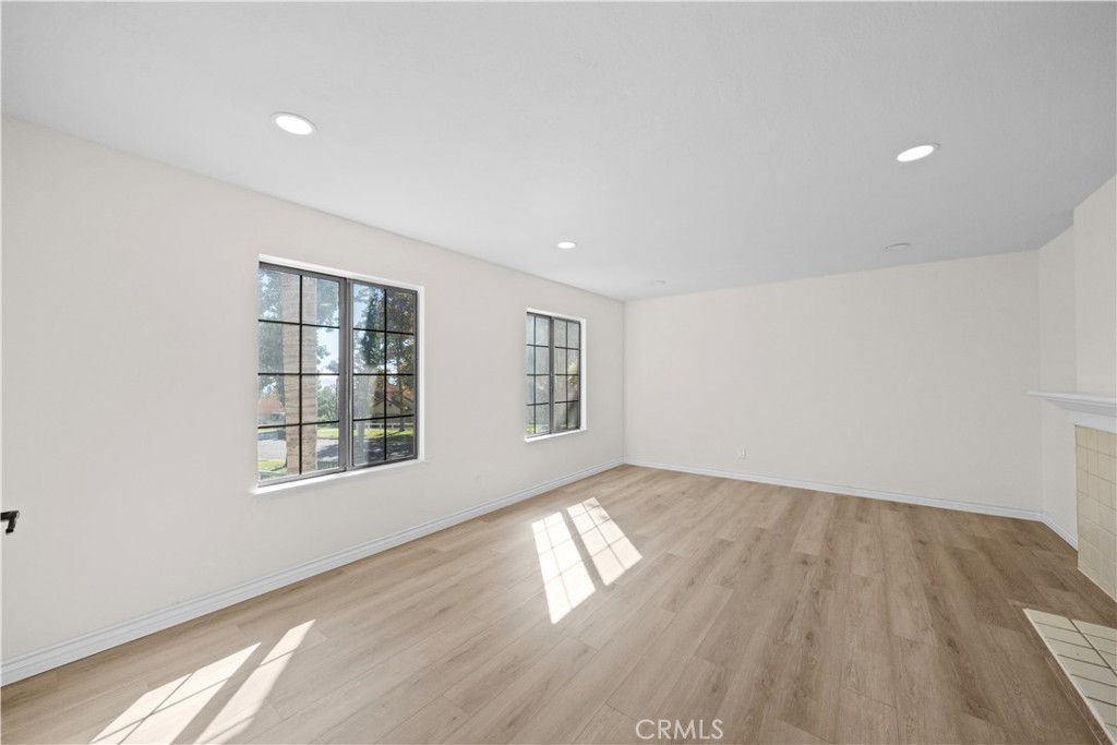 5498 Shadow Lane Rancho Cucamonga, CA 91737 - Photo 25 of 51 an empty room with wooden floor and windows