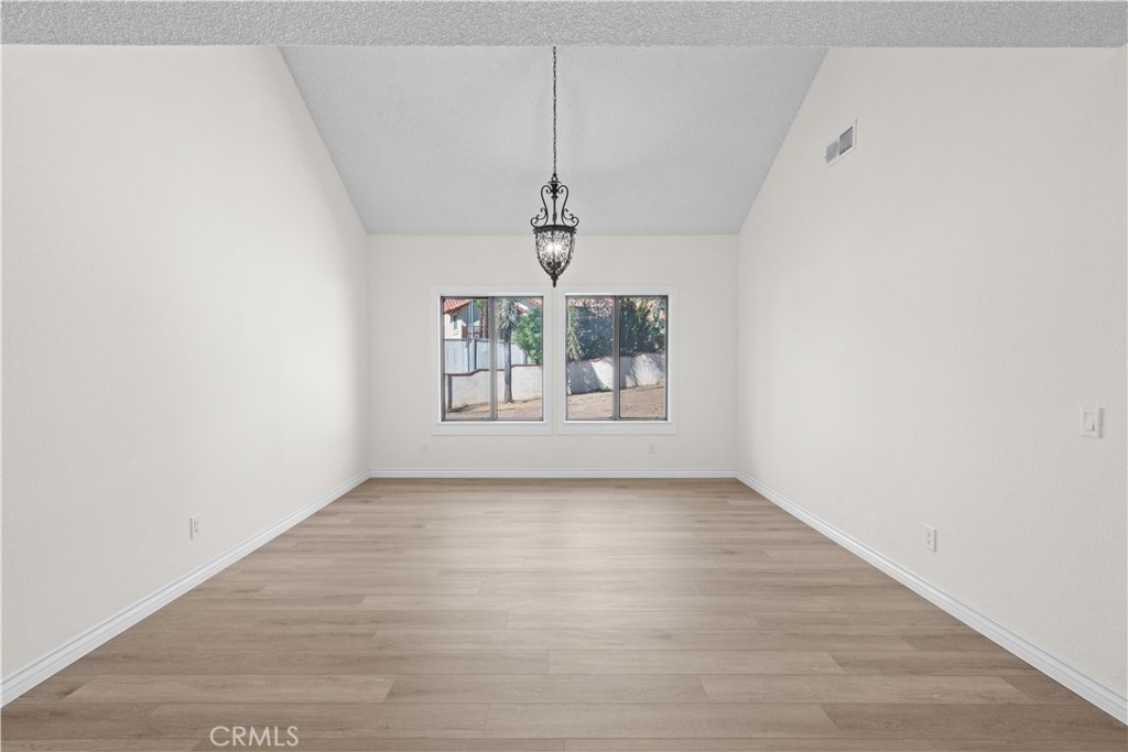 5498 Shadow Lane Rancho Cucamonga, CA 91737 - Photo 26 of 51 an empty room with windows and chandelier fan