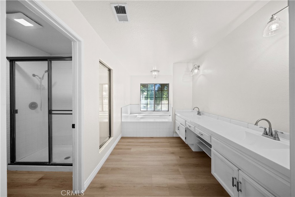 5498 Shadow Lane Rancho Cucamonga, CA 91737 - Photo 31 of 51 a bathroom with a tub sink and mirror