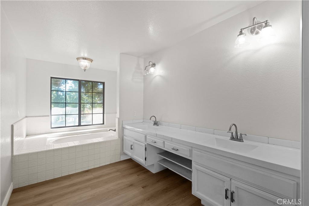 5498 Shadow Lane Rancho Cucamonga, CA 91737 - Photo 32 of 51 a bathroom with a double vanity sink and a bathtub