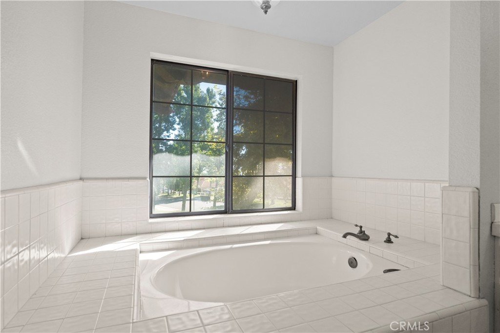 5498 Shadow Lane Rancho Cucamonga, CA 91737 - Photo 33 of 51 a bathroom with a bathtub and window