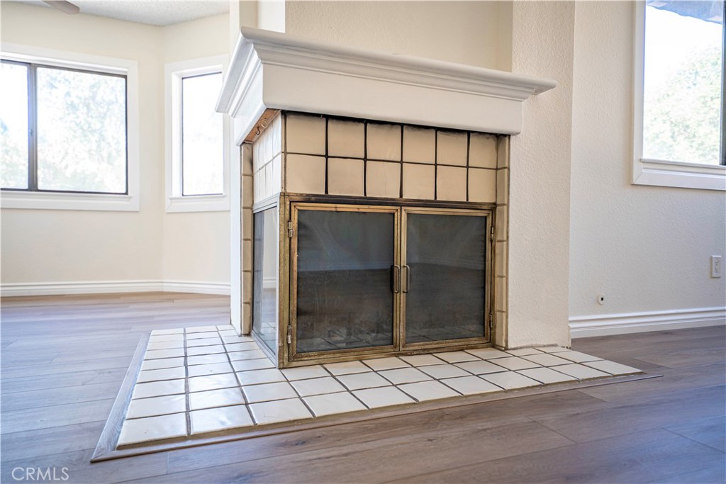 5498 Shadow Lane Rancho Cucamonga, CA 91737 - Photo 36 of 51 an empty room with wooden floor and windows