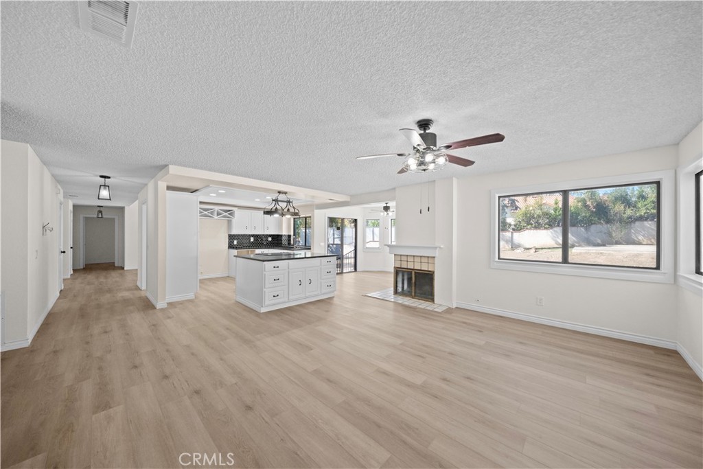 5498 Shadow Lane Rancho Cucamonga, CA 91737 - Photo 6 of 51 a view of a livingroom with furniture a ceiling fan and wooden floor