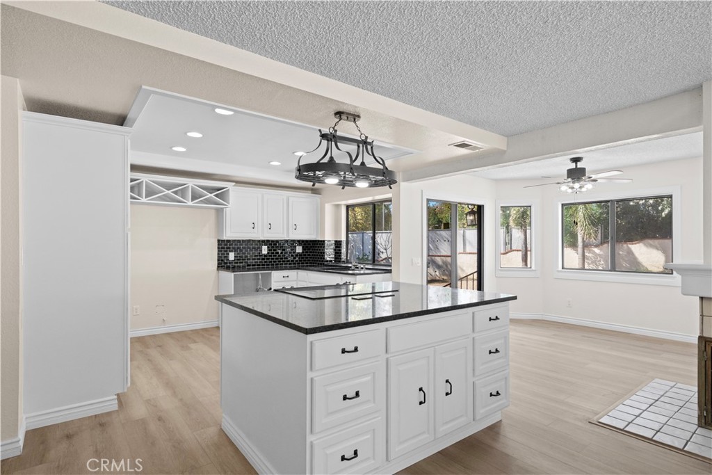 5498 Shadow Lane Rancho Cucamonga, CA 91737 - Photo 7 of 51 a kitchen with a white cabinets and chandelier