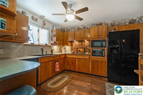 a kitchen with stainless steel appliances granite countertop a sink and cabinets