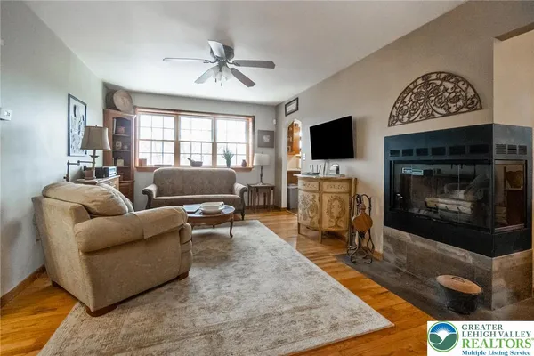 a living room with furniture a flat screen tv and a fireplace