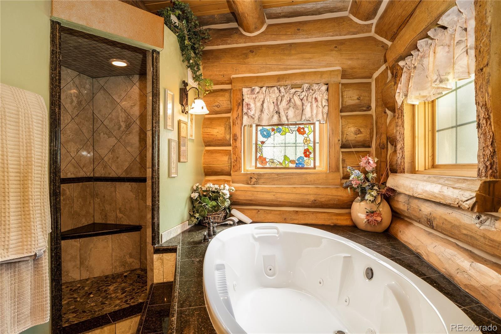 160 County Road Tabernash, CO 80478 - Photo 13 of 33 a bathroom with a tub and a large window