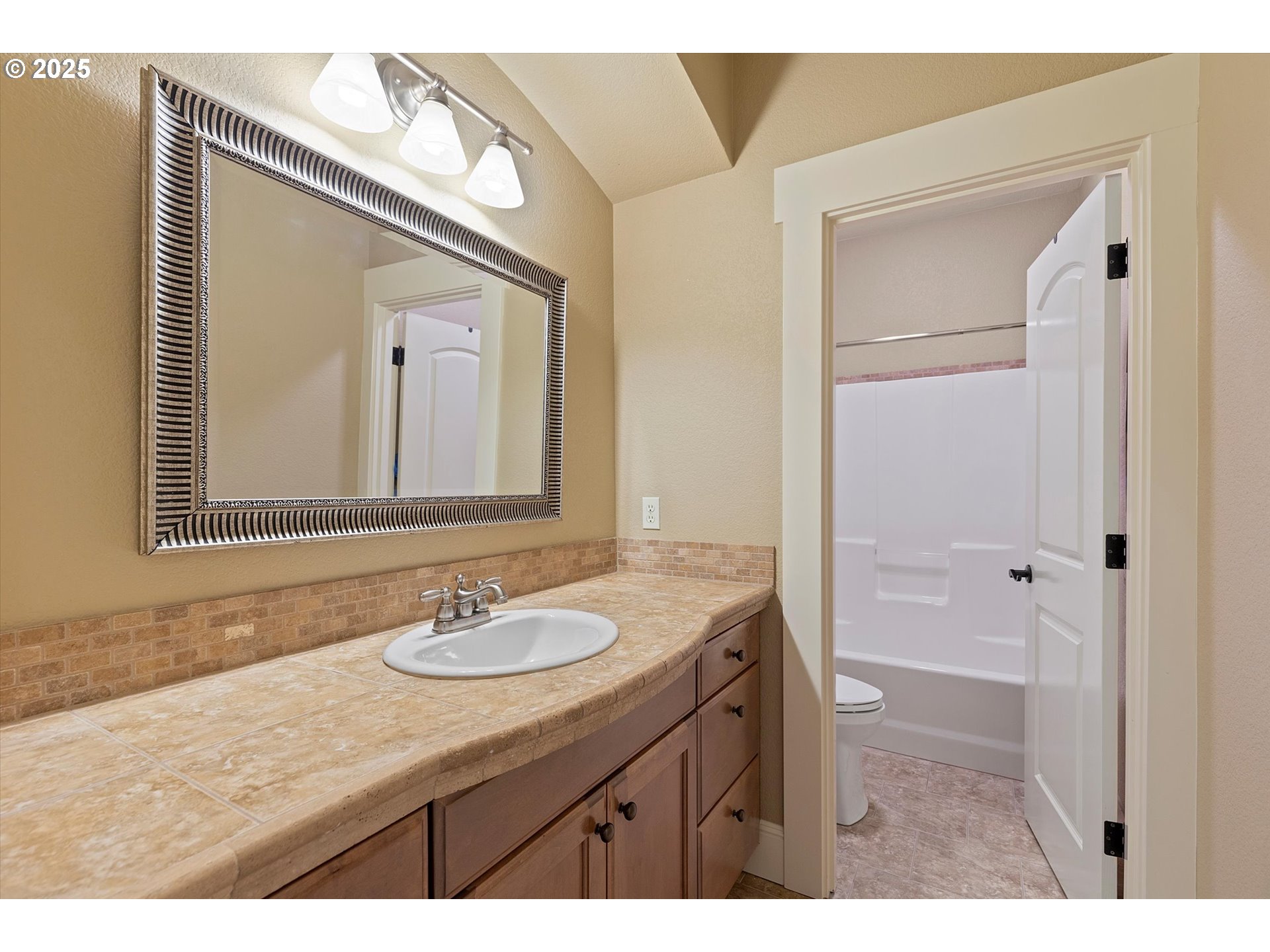 2875 Southeast Elliott Drive Gresham, OR 97080 - Photo 24 of 48 a bathroom with a granite countertop sink a mirror and a shower
