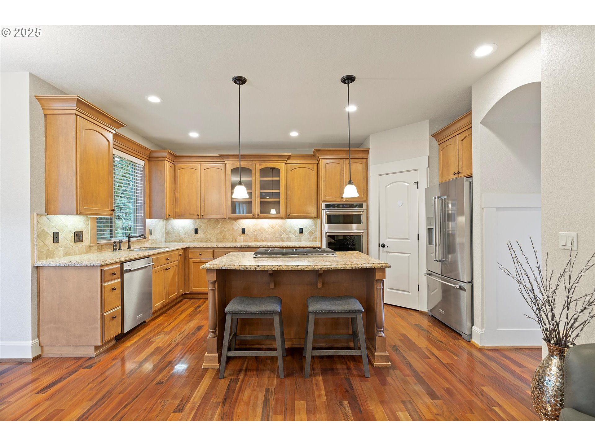 2875 Southeast Elliott Drive Gresham, OR 97080 - Photo 8 of 48 a large kitchen with kitchen island a dining table chairs stainless steel appliances and cabinets