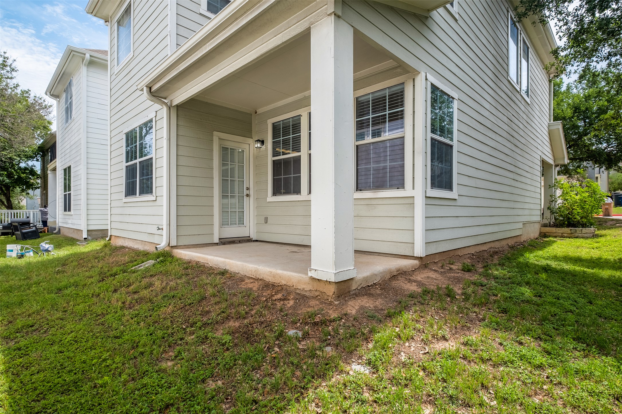 6715 Windrift Way, Unit 8 Austin, TX 78745 - Photo 23 of 24 A charming covered patio extends from the home's rear, offering a tranquil outdoor retreat.