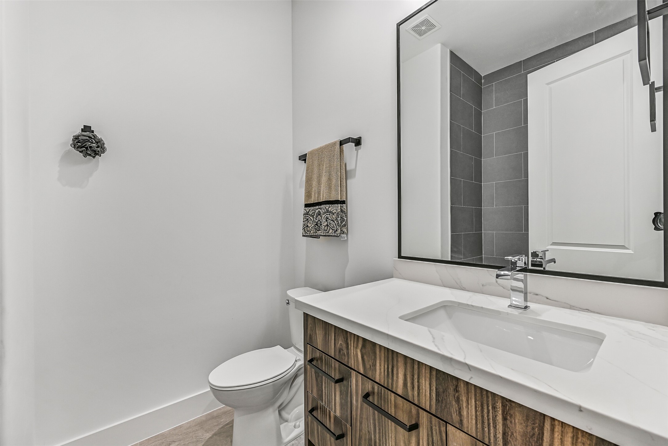7627 Scott Avenue Manvel, TX 77578 - Photo 29 of 50 a bathroom with a granite countertop sink a toilet and a mirror