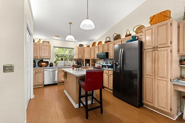 a kitchen with kitchen island granite countertop a stove and a sink