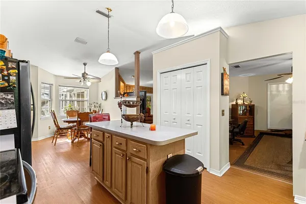 a view of a dining room and livingroom with furniture wooden floor a chandelier