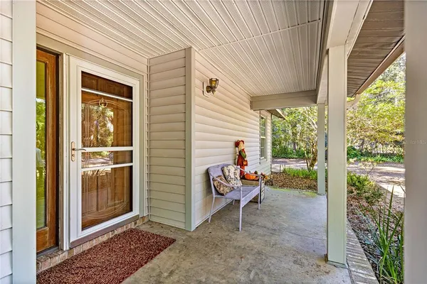 a view of a two chairs in the porch with wooden floor