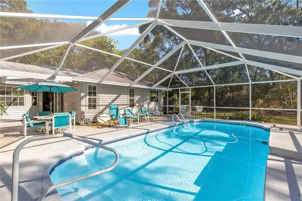 a view of swimming pool and trees in the background