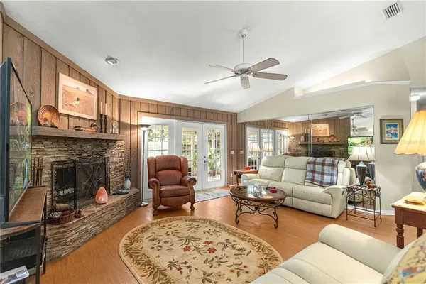 a living room with furniture a fireplace and a flat screen tv