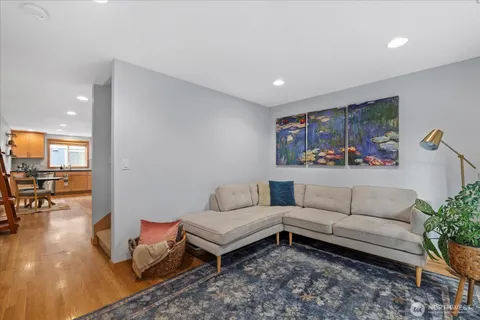 a living room with furniture and wooden floor