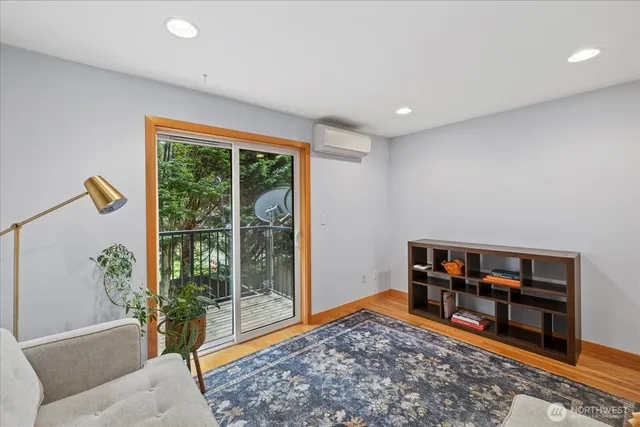 a living room with furniture and a book shelf