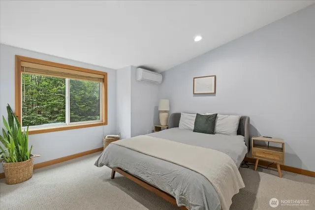 a bedroom with a bed and a potted plant