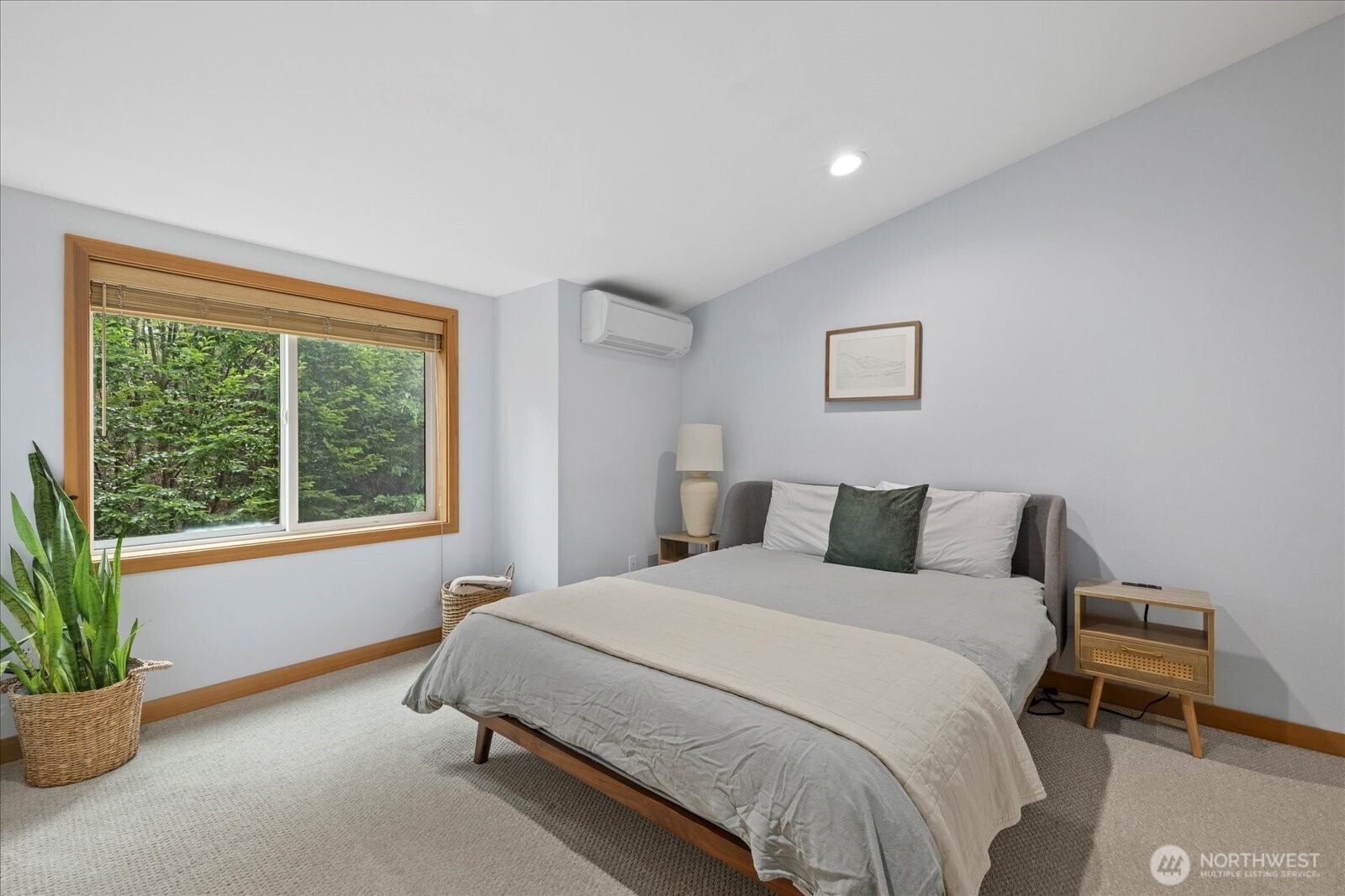 9748 4th Avenue Northwest, Unit B Seattle, WA 98117 - Photo 18 of 24 a bedroom with a bed and a potted plant