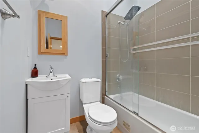 a white toilet sitting next to a bath tub