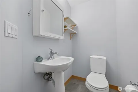a white toilet sitting next to a bathroom sink