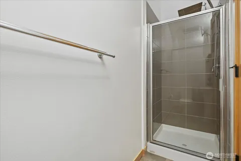 a bathroom with a glass shower door