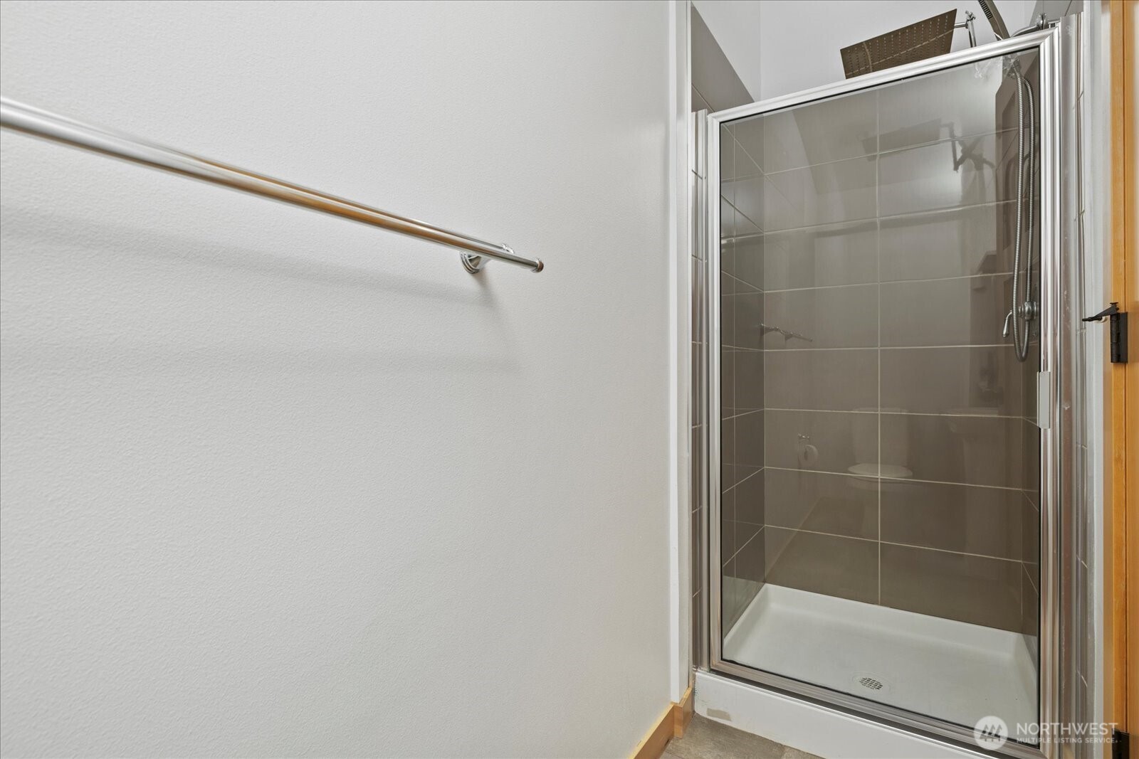 9748 4th Avenue Northwest, Unit B Seattle, WA 98117 - Photo 23 of 24 a bathroom with a glass shower door