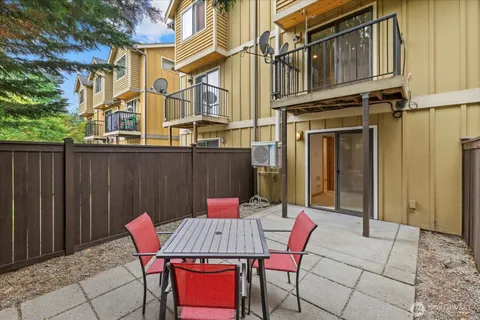 a view of a patio with table and chairs