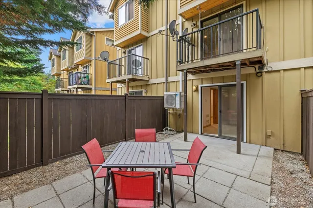 a view of a patio with table and chairs