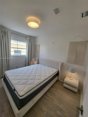 a bed sitting in a bedroom next to a window