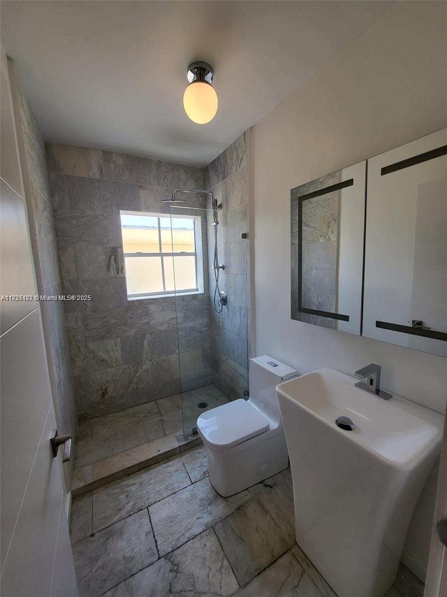 810 7th Street, Unit 206 Miami Beach, FL 33139 - Photo 6 of 7 a bathroom with a sink toilet and shower