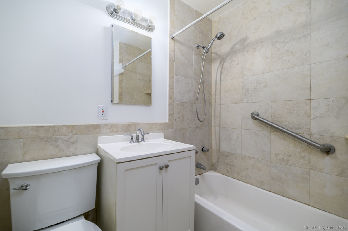 91 Strawberry Hill Avenue, Unit 331 Stamford, CT 06902 - Photo 12 of 19 a bathroom with a sink a toilet and shower