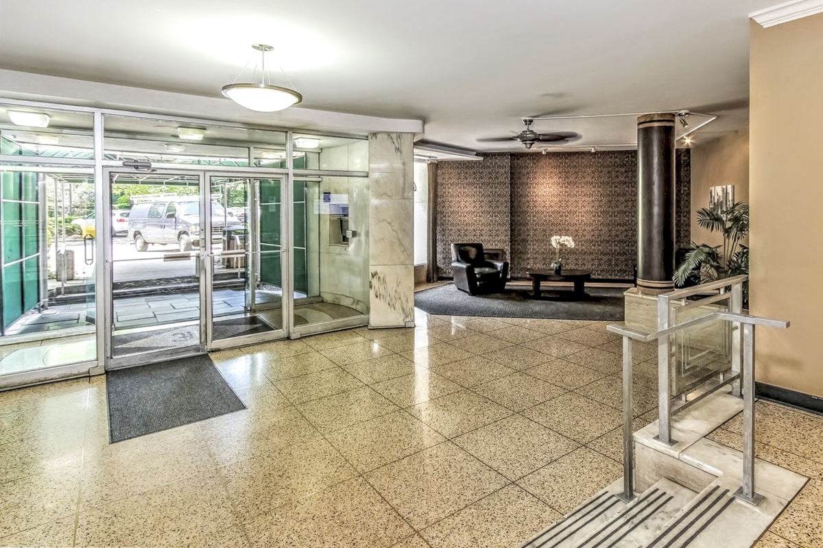 91 Strawberry Hill Avenue, Unit 331 Stamford, CT 06902 - Photo 2 of 19 a lobby with furniture and floor to ceiling window