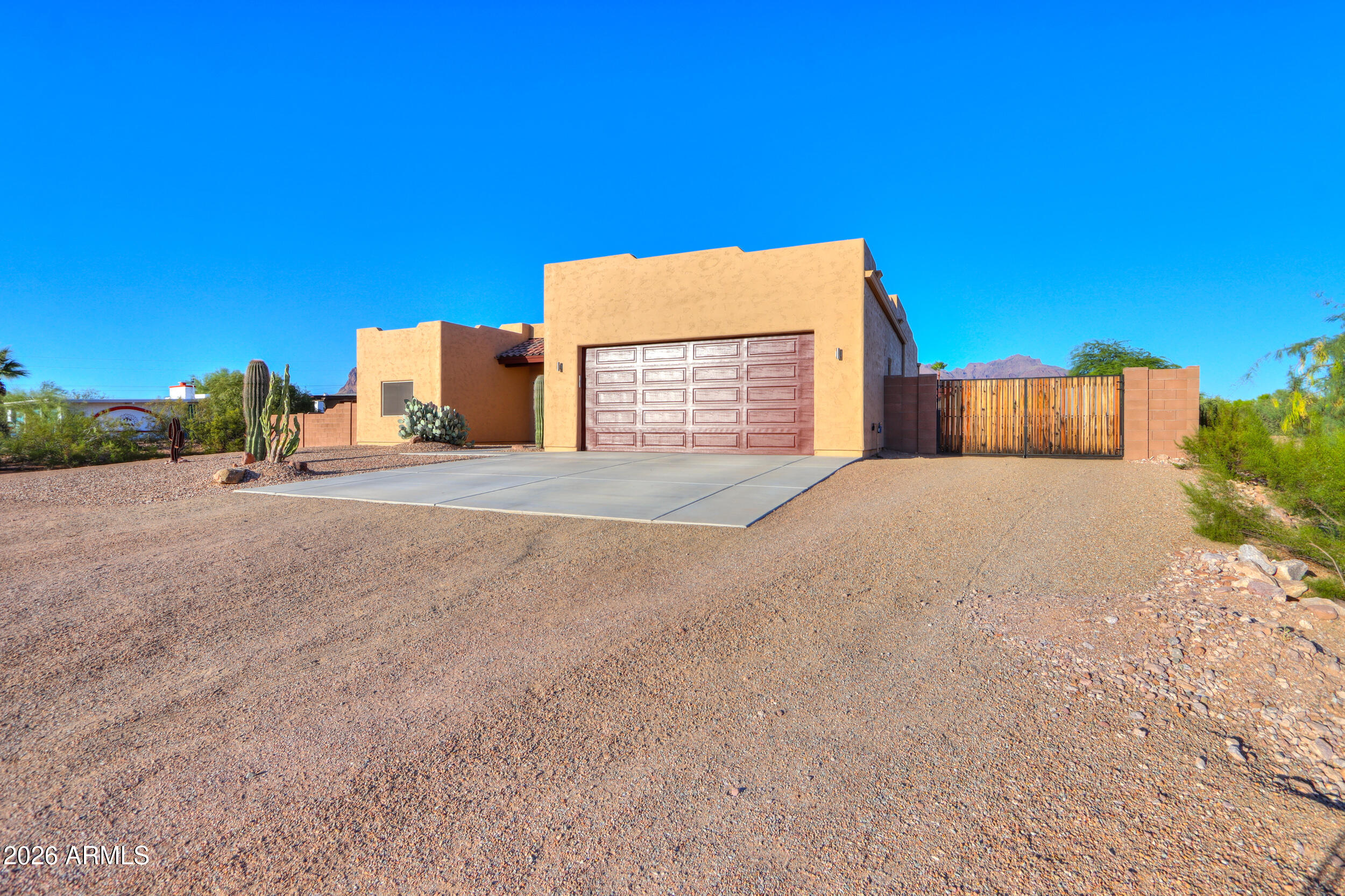 1487 South Mountain View Road Apache Junction, AZ 85119 - Photo 8 of 60 a view of a house with a yard and potted plants