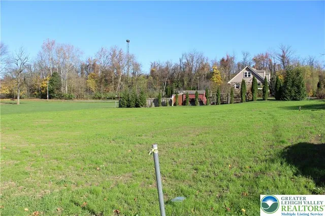 a view of a field of grass and trees